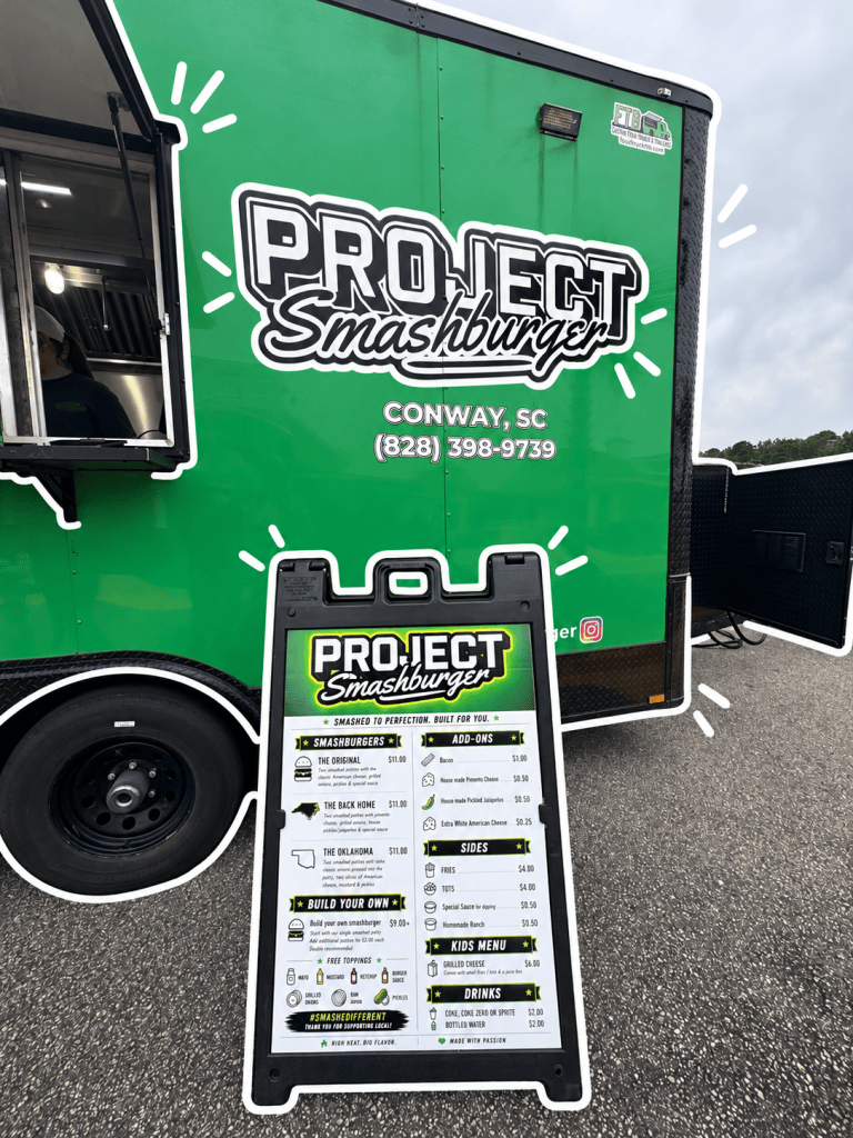 A food truck named Project Smashburger featuring a bright green exterior with a menu board showcasing various burger options, sides, and drinks.